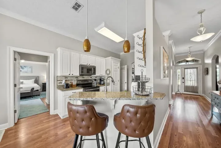 Coastal kitchen island with bar seating and modern appliances